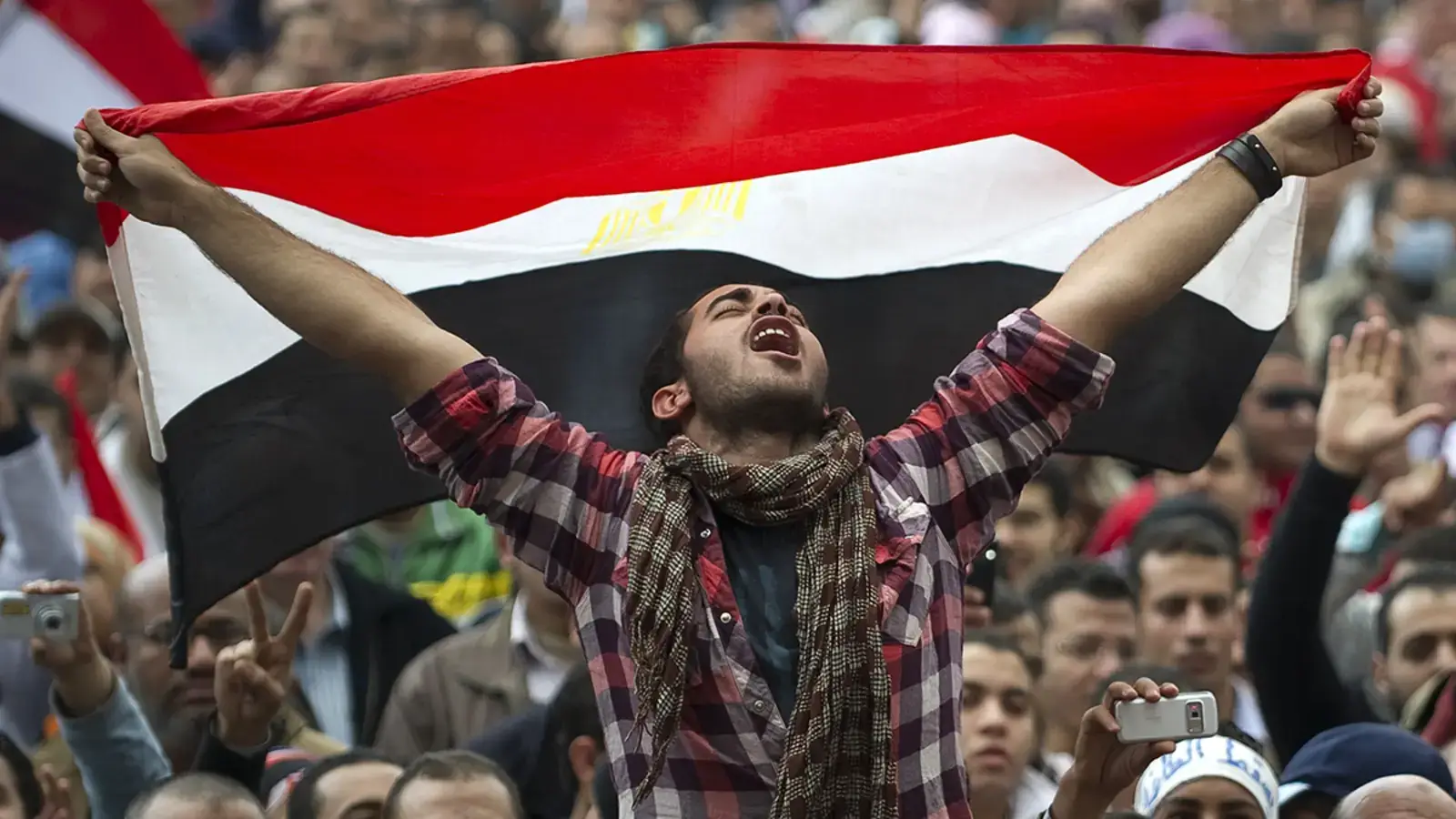 guy holding the egyptian flag during arab spring